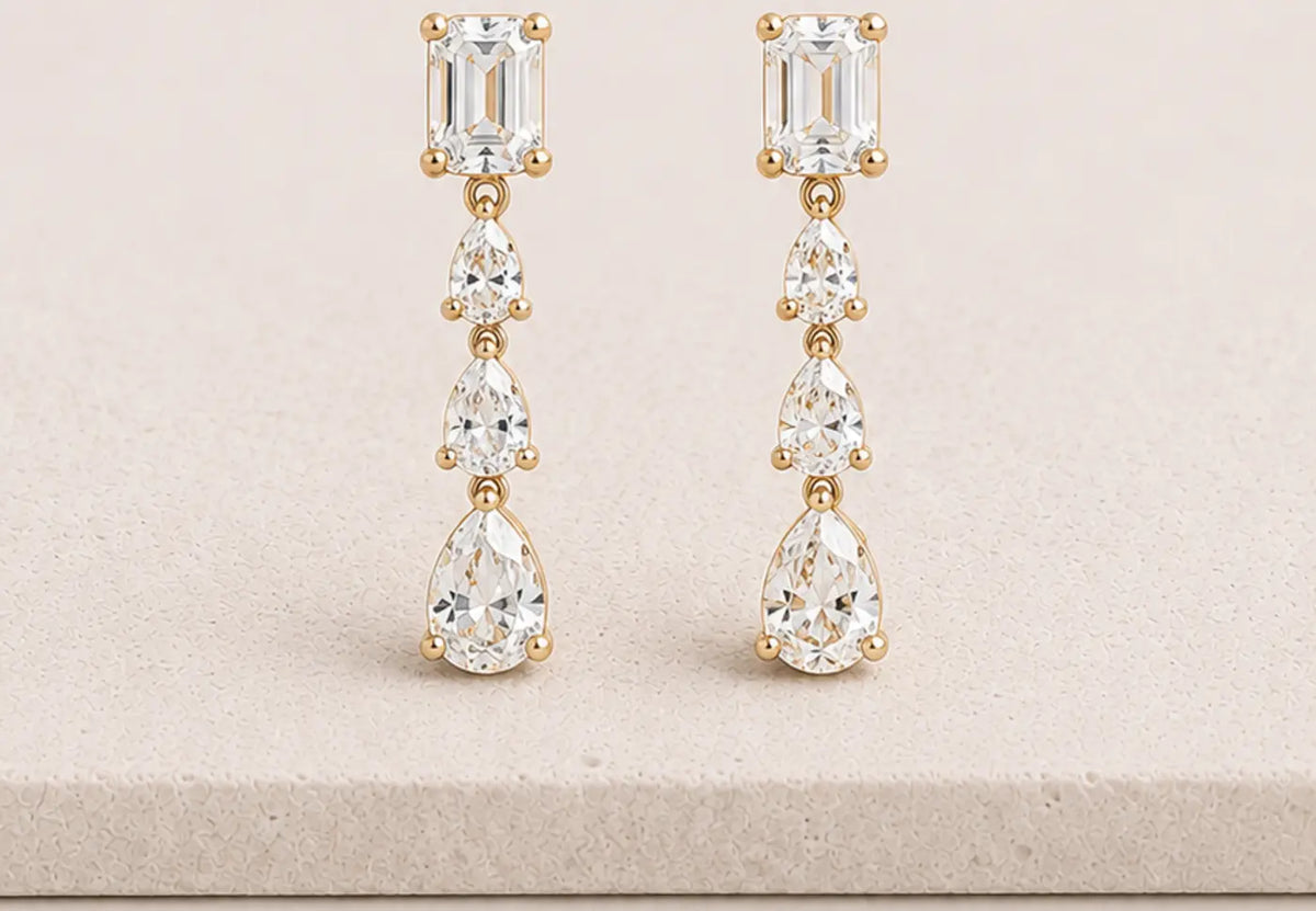 CHÔHANÉ emerald and pear-cut diamond drop earrings on ivory stone